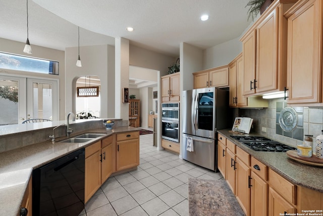 kitchen with sink, backsplash, hanging light fixtures, light tile patterned floors, and stainless steel appliances