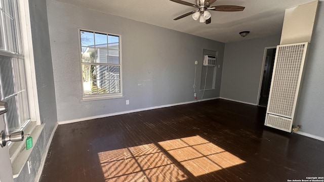 unfurnished room featuring a wall mounted air conditioner, dark wood-type flooring, and ceiling fan