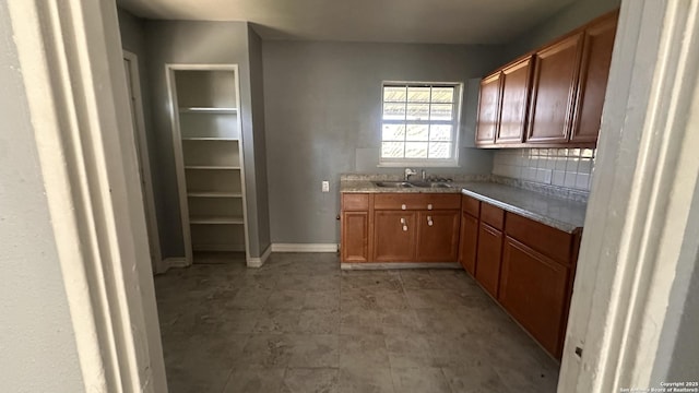 kitchen featuring tasteful backsplash and sink