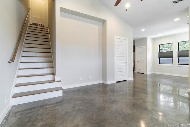 stairway with concrete flooring, vaulted ceiling, and ceiling fan