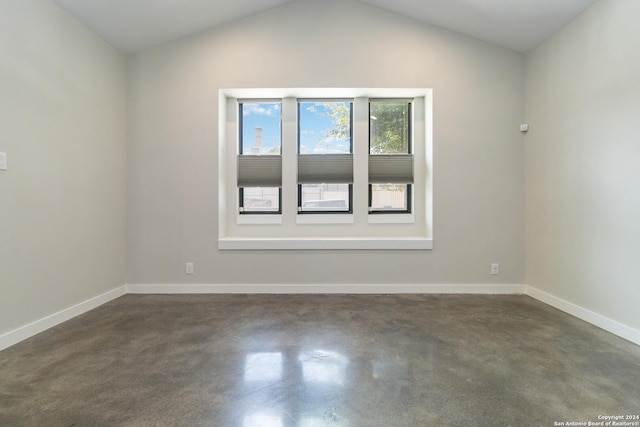 empty room with lofted ceiling