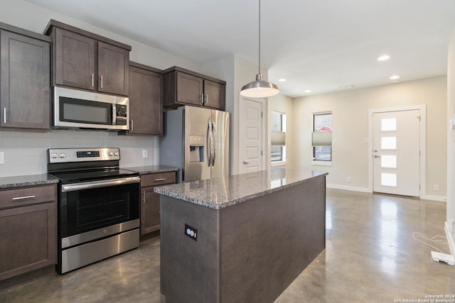 kitchen with appliances with stainless steel finishes, pendant lighting, dark stone countertops, concrete floors, and dark brown cabinetry