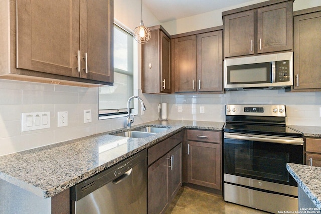 kitchen with stainless steel appliances, tasteful backsplash, light stone countertops, and sink