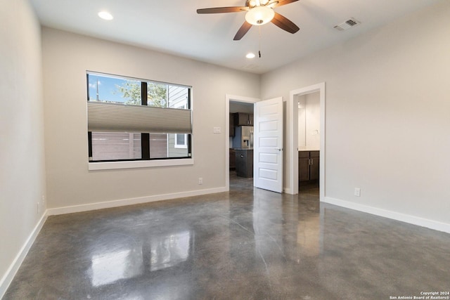 unfurnished bedroom featuring ensuite bath, ceiling fan, and stainless steel refrigerator with ice dispenser