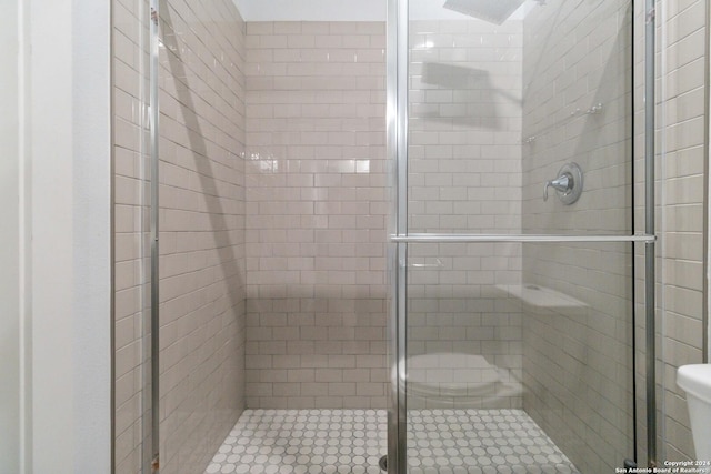 bathroom with a shower with door