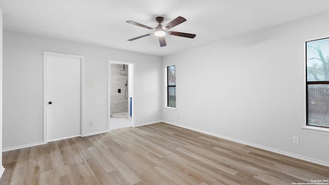 unfurnished bedroom featuring light hardwood / wood-style floors, ceiling fan, and ensuite bathroom