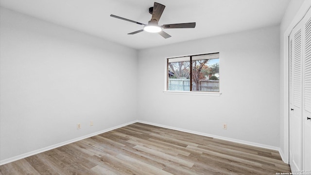 unfurnished bedroom featuring a closet, ceiling fan, and light wood-type flooring