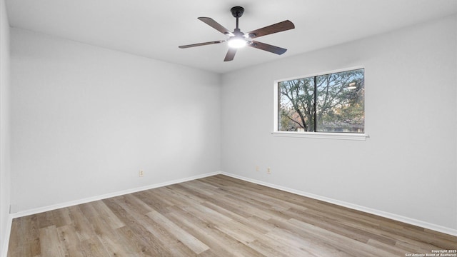 empty room with ceiling fan and light hardwood / wood-style flooring