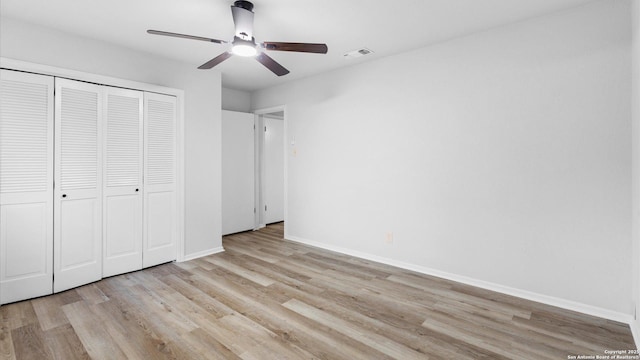 unfurnished bedroom featuring light wood-type flooring, ceiling fan, and a closet