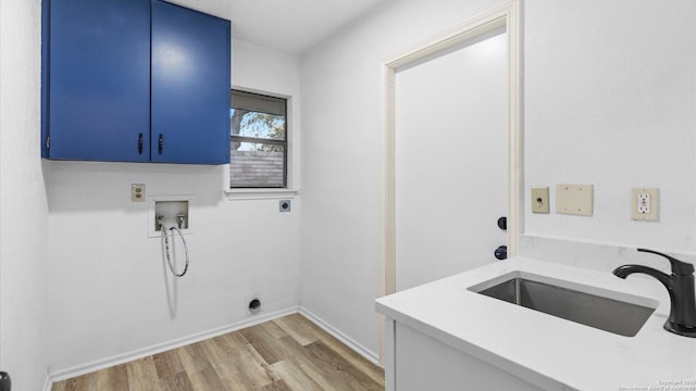 laundry area featuring sink, cabinets, light wood-type flooring, hookup for a washing machine, and electric dryer hookup