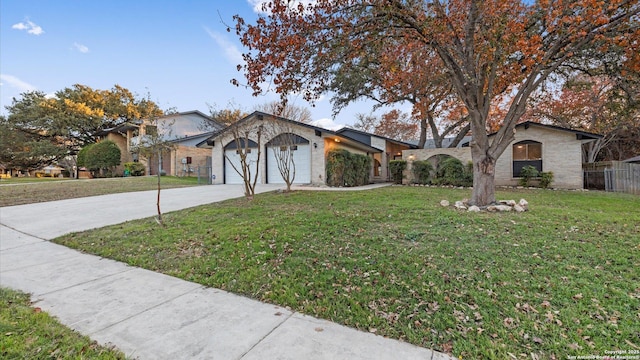 ranch-style home featuring a garage and a front lawn