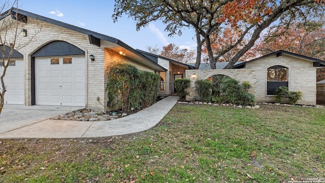 view of property exterior featuring a garage and a lawn