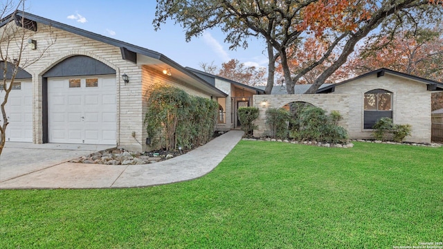 view of front of house featuring a garage and a front lawn