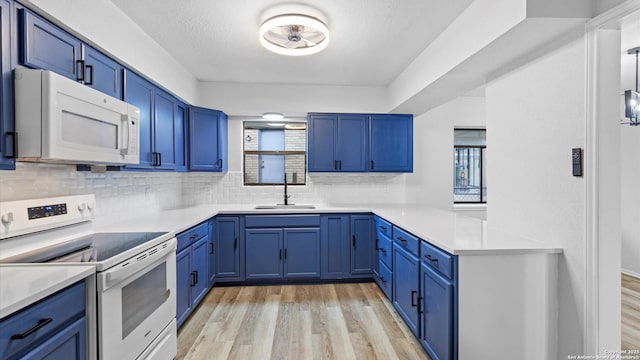 kitchen featuring blue cabinets, sink, light wood-type flooring, white appliances, and backsplash