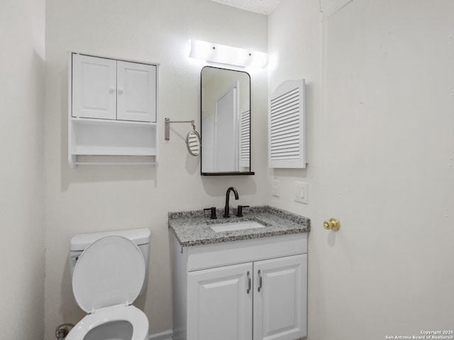 bathroom featuring vanity, radiator, a textured ceiling, and toilet