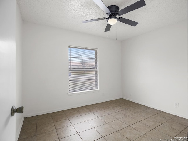 tiled empty room featuring ceiling fan and a textured ceiling