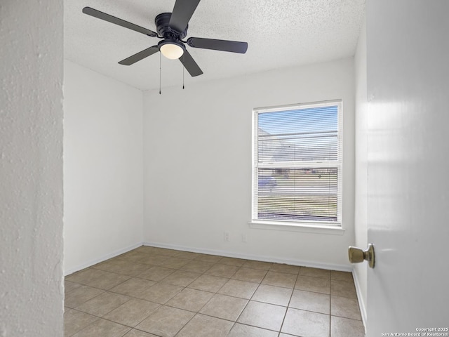 unfurnished room featuring light tile patterned flooring, ceiling fan, and a textured ceiling