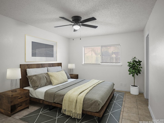 tiled bedroom with a textured ceiling and ceiling fan