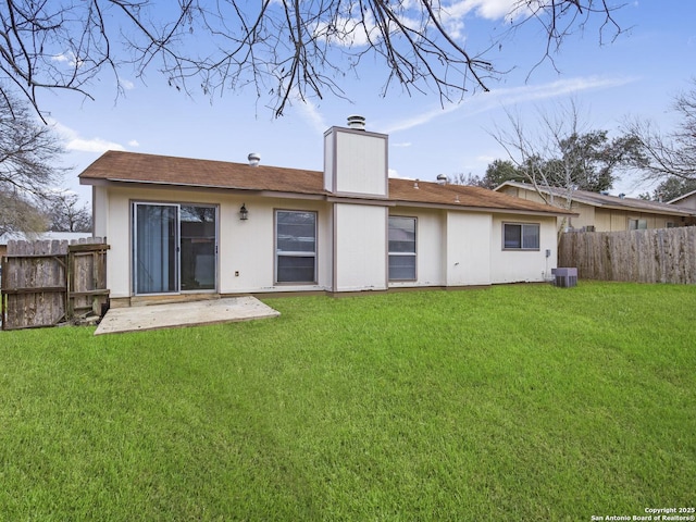 back of house featuring a lawn, a patio, and central air condition unit