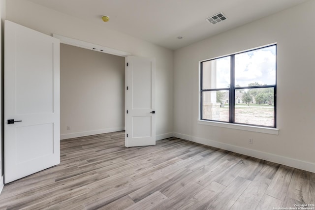 empty room featuring light hardwood / wood-style floors and a healthy amount of sunlight