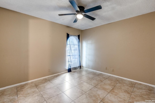 unfurnished room featuring ceiling fan, a textured ceiling, and light tile patterned floors