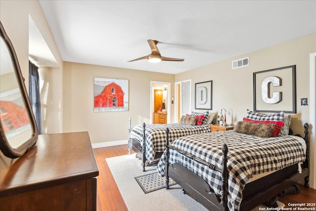 bedroom with ensuite bathroom, ceiling fan, and light hardwood / wood-style floors