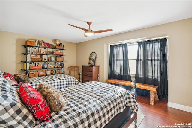 bedroom featuring dark hardwood / wood-style flooring and ceiling fan