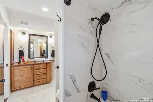 bathroom featuring vanity and a tile shower