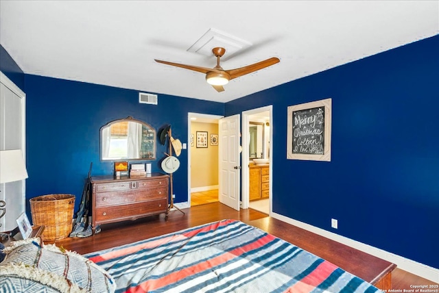 bedroom with dark hardwood / wood-style flooring, connected bathroom, and ceiling fan