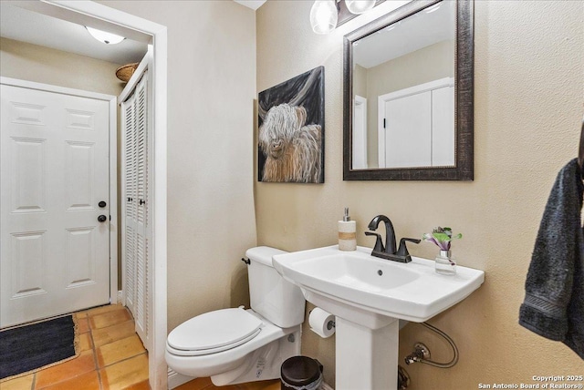 bathroom featuring tile patterned flooring and toilet