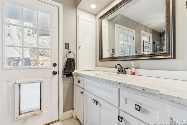 bathroom with tile patterned floors and vanity