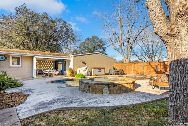 view of patio featuring a pool with hot tub