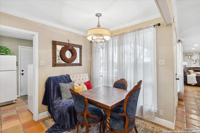 tiled dining room with an inviting chandelier and ornamental molding