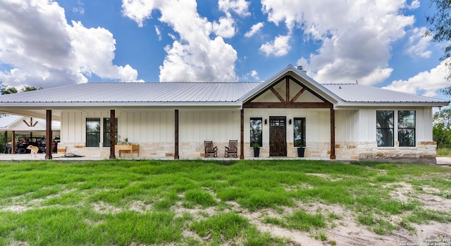 rear view of property with a yard