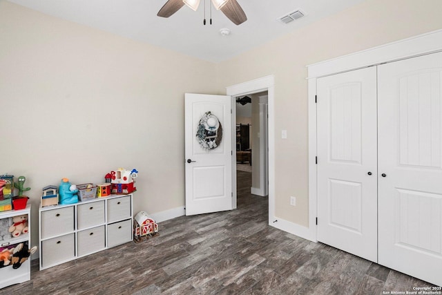 interior space with dark wood-type flooring and ceiling fan