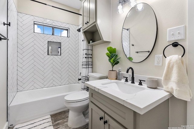 full bathroom with tiled shower / bath, vanity, toilet, and hardwood / wood-style floors