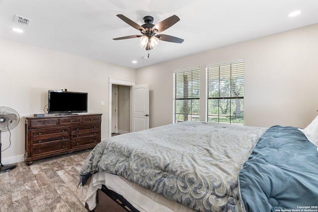 bedroom with light hardwood / wood-style flooring and ceiling fan