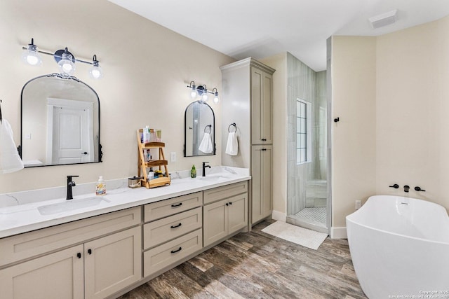 bathroom with independent shower and bath, vanity, and hardwood / wood-style floors