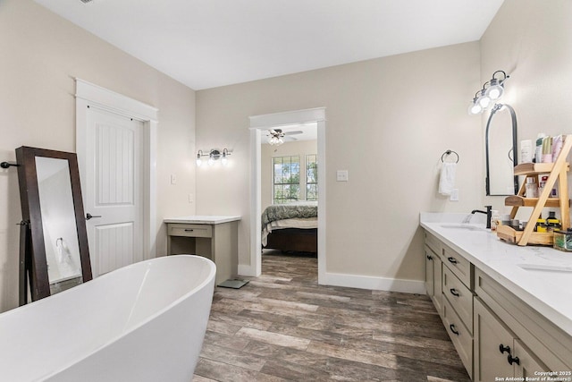 bathroom with vanity, hardwood / wood-style flooring, and a bathing tub