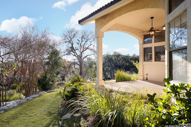 view of yard with ceiling fan