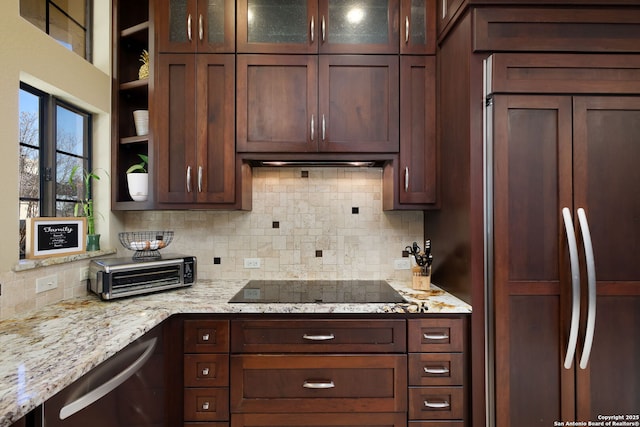 kitchen featuring backsplash, light stone counters, black electric stovetop, paneled built in fridge, and stainless steel dishwasher