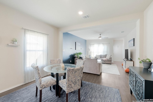 dining space featuring ceiling fan, plenty of natural light, and dark hardwood / wood-style flooring