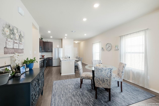 dining space featuring dark hardwood / wood-style flooring and sink