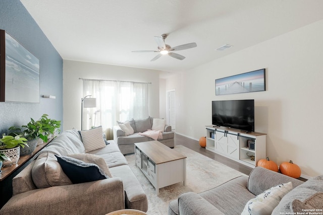 living room featuring ceiling fan and light hardwood / wood-style flooring