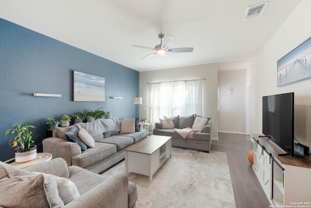 living room featuring ceiling fan and light hardwood / wood-style flooring