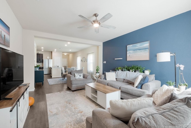 living room featuring ceiling fan and wood-type flooring