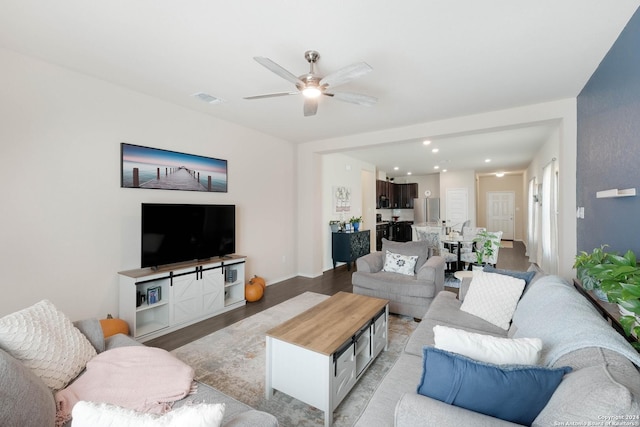 living room featuring ceiling fan and light hardwood / wood-style flooring