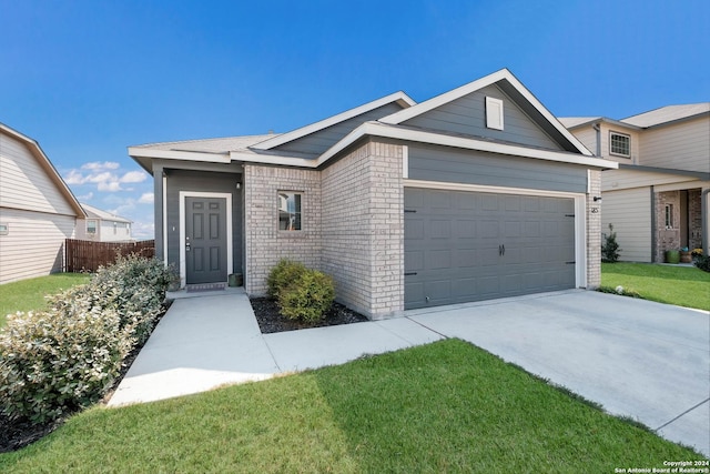 view of front of house with a garage and a front yard