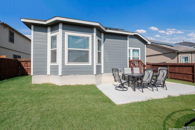 back of house featuring a yard and a patio