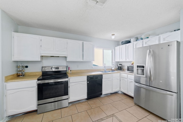 kitchen featuring stainless steel appliances, white cabinetry, sink, and a textured ceiling